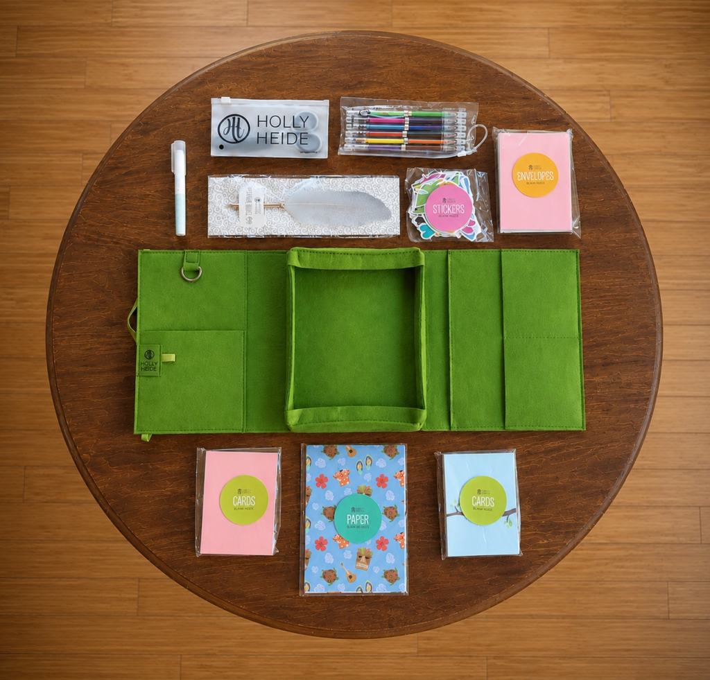 Letter Writing Kit with stationery, note cards, envelopes, decorative paper, gel pens, stickers, and writing supplies arranged on a round wooden table.