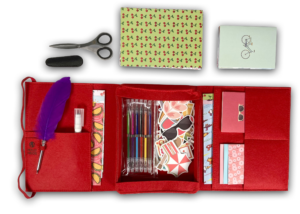 Cherry Red Mobile Writing Desk open with paper, gel pens, stickers, feather pen and craft scissors