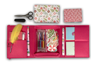 Hot Pink Mobile Writing Desk open with paper, gel pens, stickers, feather pen and craft scissors