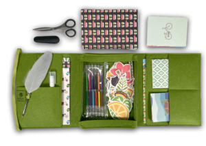 Moss Green Mobile Writing Desk open with paper, gel pens, stickers, feather pen and craft scissors