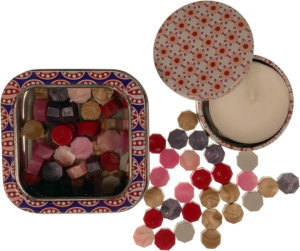 Berry Mix sealing wax pearls by Holly Heide in berry red, pink, plum, ivory and metallic tones with storage tin and coordinating candle.
