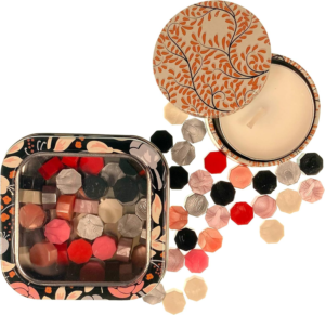 Classic Mix sealing wax pearls by Holly Heide in red, pink, ivory, black and silver tones with floral storage tin and coordinating candle.