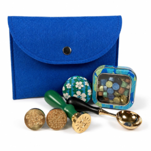 Holly Heide Ocean Blue Wax Seal Kit with blue felt pouch, three brass stamp designs, wax pearls, candle tin and gold pouring spoon.