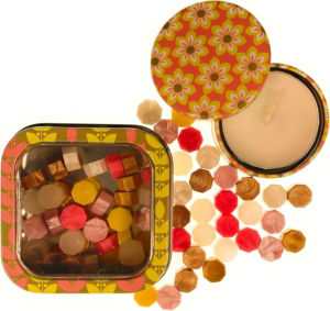 Pink Mix sealing wax pearls by Holly Heide in pink, coral, yellow, ivory and gold with decorative storage tin and coordinating candle.